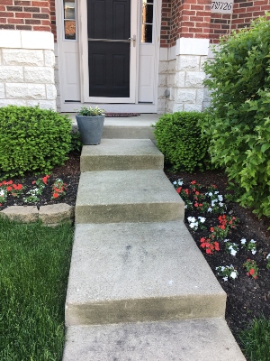 Front porch with newly in-ground planted Beacon White and Red Impatiens