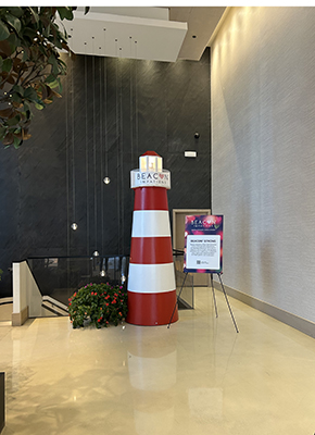 A lighthouse prop that is striped red and whtie